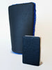 A blue Klaren clay bar mitt standing side by side with a white Klaren Pocket Clay for a size comparison